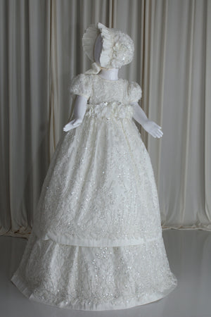 Full-length view of the Anahi christening gown in luminous pearl tone