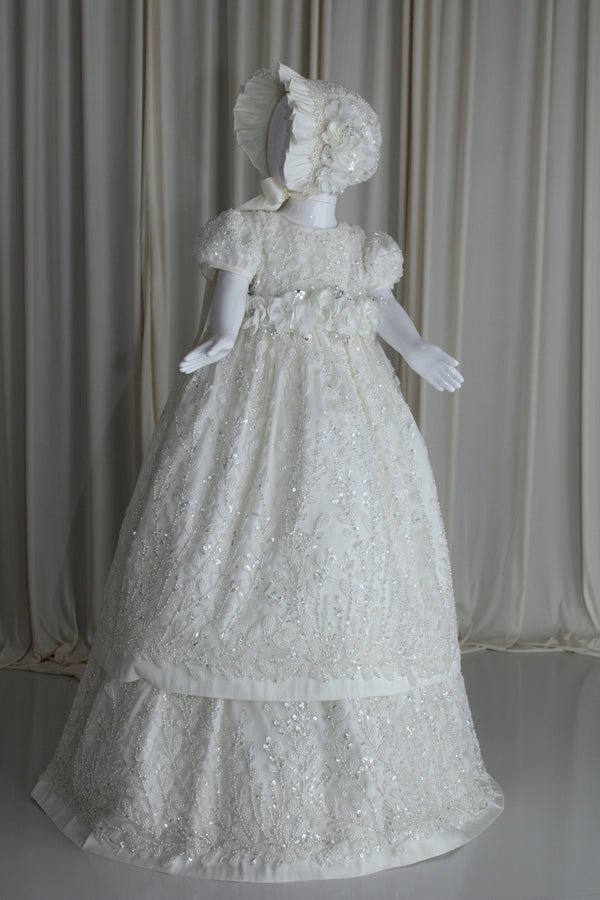 Full-length view of the Anahi christening gown in luminous pearl tone