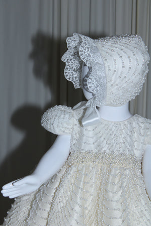 Full-length view of the Amira christening gown in soft ivory