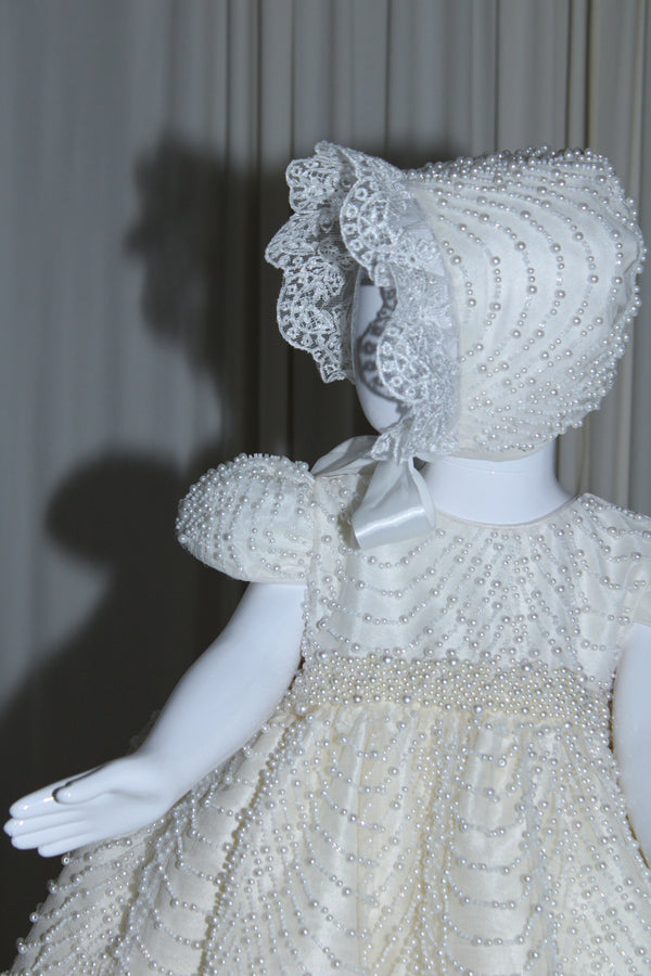 Full-length view of the Amira christening gown in soft ivory