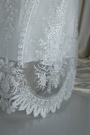 Close view of the Aytana gown beaded embroidery and neckline detail