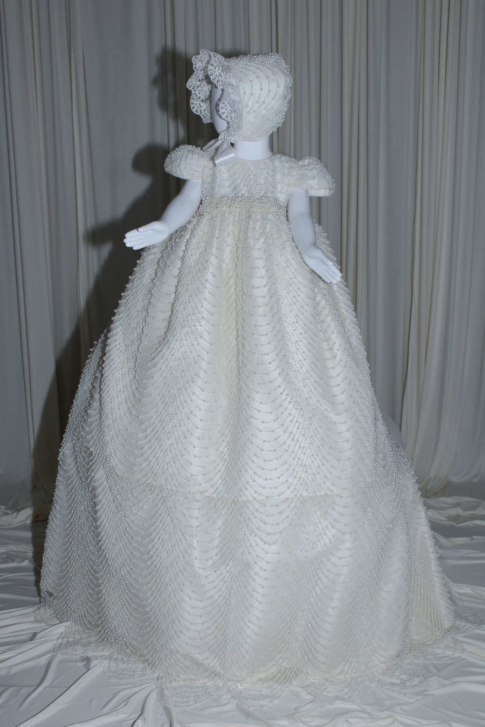 Amira baptism gown for baby girl with cascading pearl embellishments and matching bonnet